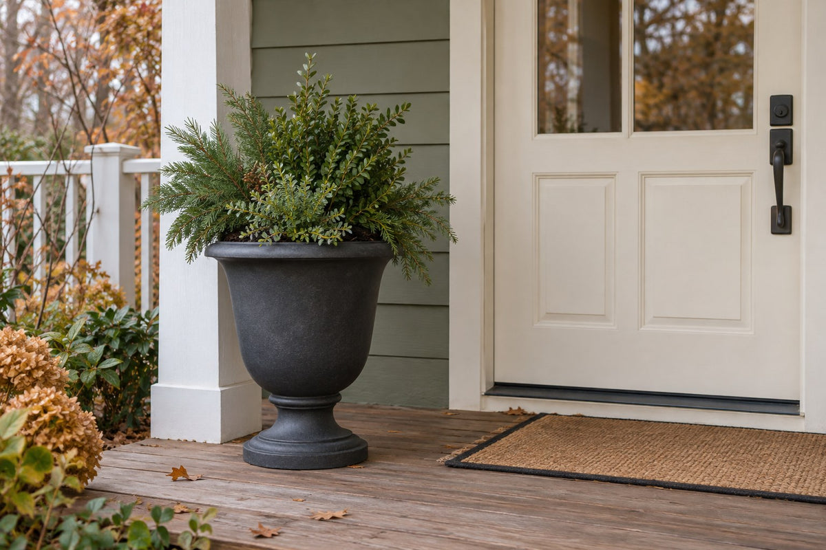 Heavy decorative porch planter with a simple seasonal display in a removable inner pot