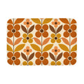 A rectangular mid-century modern style doormat with a bold geometric floral pattern in retro burnt orange, mustard yellow, and brown on a cream background.