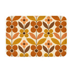 A rectangular mid-century modern style doormat with a bold geometric floral pattern in retro burnt orange, mustard yellow, and brown on a cream background.