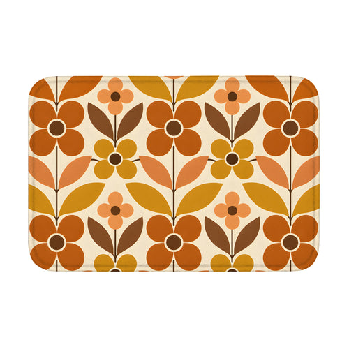 A rectangular mid-century modern style doormat with a bold geometric floral pattern in retro burnt orange, mustard yellow, and brown on a cream background.