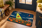 Alien Pumpkin Farm Printed Floor Mat, lifestyle view 3: One mat in a tidy indoor mudroom beside a small bench, photographed slightly above with realistic 16 by 24 inch scale.