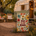 Be Kind floral garden flag styled beside a cozy camper campsite