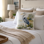 Watercolor heron pillow cover styled on a cozy neutral bedroom bed.