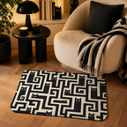 Black cat maze floor mat placed beside a cozy lounge chair.