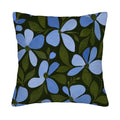 Square blue floral pillow cover with dark green leaves isolated on a white background.