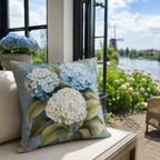 Blue hydrangea pillow cover styled by a window overlooking a Dutch canal.