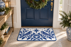Blue & White Christmas Songbird Printed Floor Mat floor mat, lifestyle view 2: An elegant entryway with navy-painted front door, white paneled walls and light stone flooring.
