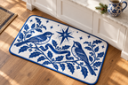Blue & White Christmas Songbird Printed Floor Mat floor mat, lifestyle view 4: Close slightly overhead editorial product photograph of the exact reference floor mat beside a white kitchen island and one cobalt ceramic pitcher on the countertop.