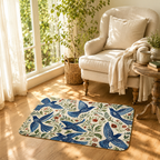 A decorative vintage bluebird mat styled on light hardwood floors next to a cozy cream armchair.