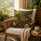 A vintage botanical tile-print cushion resting on a retro wooden armchair with rattan backing, featuring a soft fringed throw blanket and a scenic window filled with green ferns.