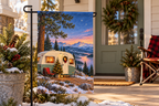 Christmas Camper Printed Garden Flag, lifestyle view 1: One flag on a simple separate black L-shaped garden stake beside a front porch planter, all of the flag readable, late-afternoon natural light.