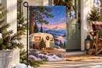 Christmas Camper Printed Garden Flag, lifestyle view 3: Closer view of the flag on its separate black L-shaped stake near a porch post, the real cloth top sleeve threading over the horizontal bar, print clearly readable.