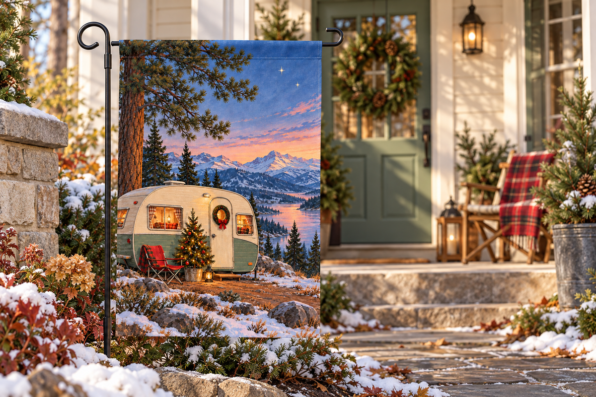 Christmas Camper Printed Garden Flag, lifestyle view 4: One flag on its separate black garden stake in a mailbox garden with restrained October seasonal planting, wide but product-led welcoming suburban scene.