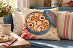 Christmas Cookie Tin Printed Pillow Cover, lifestyle view 3: Centered in front of plain pillows on a neatly made guest bed; eye-level composition, believable 18-inch pillow scale.