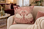 Christmas Swans & Bows Printed Velvet Pillow Cover, lifestyle view 1: Placed upright on an accent chair, nearly frontal with full print clearly visible; room-wide interior composition.