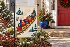 Christmas Toy Train Printed Garden Flag, lifestyle view 4: One flag on its separate black garden stake in a mailbox garden with restrained October seasonal planting, wide but product-led welcoming suburban scene.