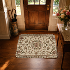 A beautiful traditional style floral doormat placed at a dark wood front door entrance next to fresh roses on a side table.