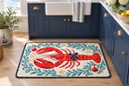 Coastal Lobster Christmas Printed Floor Mat, lifestyle view 2: One mat on the kitchen floor in front of a sink or coffee station, full printed surface readable, no furniture hiding the design.