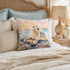 A charming seal themed accent pillow showcased on a cozy bed with pastel blue and white bedding next to a rustic woven rattan headboard and bedside lamp.