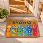 A coastal style flip-flop welcome mat placed on a sunny wooden porch floor at the open entryway of a house.