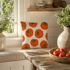 Cottagecore tomato pattern pillow cover displayed on a comfortable beige bench seat by the window.