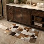 A rectangular doormat with a brown and white faux cowhide patchwork pattern on a white background.