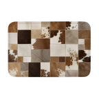 A rectangular doormat with a brown and white faux cowhide patchwork pattern on a white background.