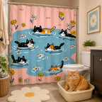 A cute cat and daisy pattern shower curtain hung in a beige tiled bathroom, with a chubby orange cat sitting inside a litter box on the floor looking at the camera.