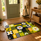 A retro daisy floral doormat styled at a home entryway next to a green front door and white sneakers.