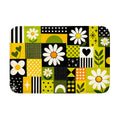 A top-down product view of a rectangular geometric doormat featuring white daisy patterns and green-yellow accents.