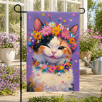 Floral calico cat garden flag displayed near a bright greenhouse porch with lavender and pastel flowers.