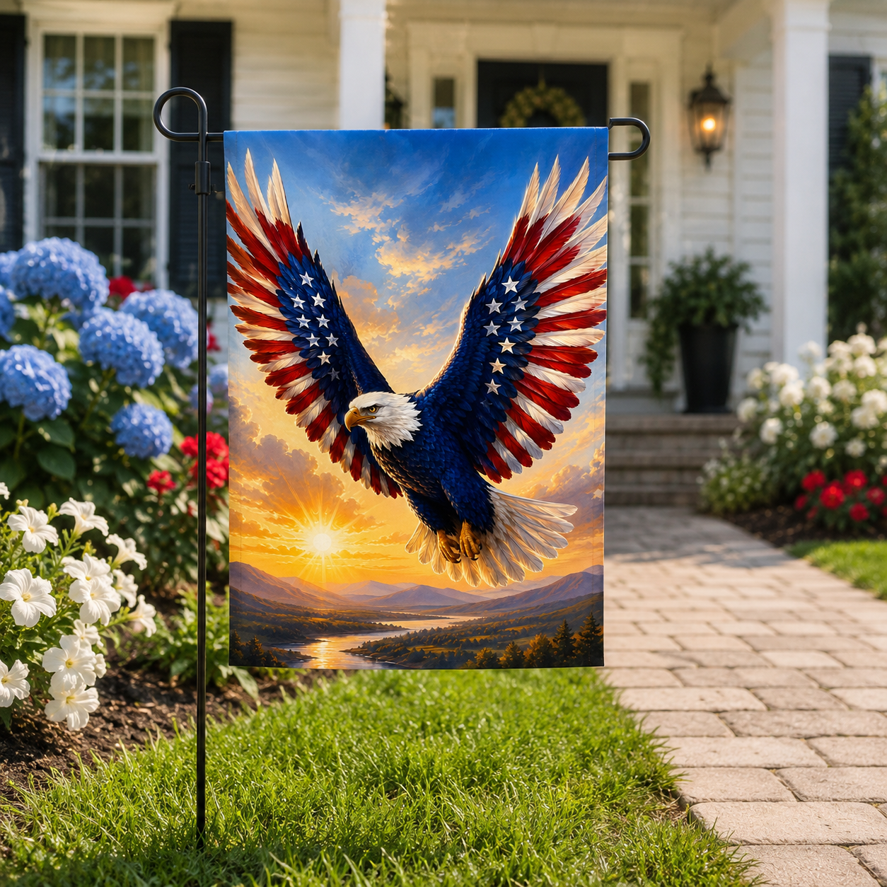 Majestic flying bald eagle garden flag with stars and stripes wings displayed along a stone paver walkway in front of a white house.