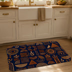 A bohemian geometric doormat styled on a wooden floor in front of a white kitchen sink.