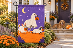 Ghost Dogs Halloween Printed Garden Flag, lifestyle view 4: One flag on its separate black garden stake in a mailbox garden with restrained October seasonal planting, wide but product-led welcoming suburban scene.