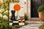 Halloween Chess Pieces Printed Garden Flag, lifestyle view 2: One flag on a separate black garden stake along a short garden path, lower garden view with planting behind; no people, full rectangle visible.