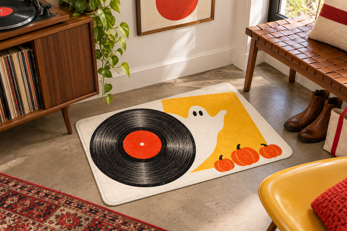 Halloween Vinyl Record Party Printed Floor Mat, lifestyle view 3: One mat in a tidy indoor mudroom beside a small bench, photographed slightly above with realistic 16 by 24 inch scale.