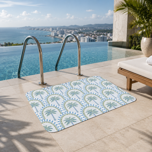 A tropical arch and palm tree accent mat on a sunny balcony next to an infinity pool with a panoramic ocean and coastal city view.