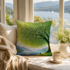 A decorative landscape pillow cover with a green tree print on a cozy window seat by a lake view.