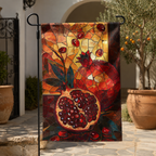 Mosaic-style pomegranate garden flag displayed beside a Mediterranean courtyard with warm earthy tones.
