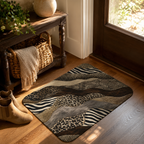 A safari-themed layered animal print doormat styling a wooden floor by a glass door entryway.