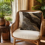Wild animal print accent pillow cover on a rattan chair surrounded by bohemian home decor.