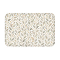 A rectangular modern botanical doormat featuring a seamless pattern of soft grey and green leaves with golden berries on a clean white background.