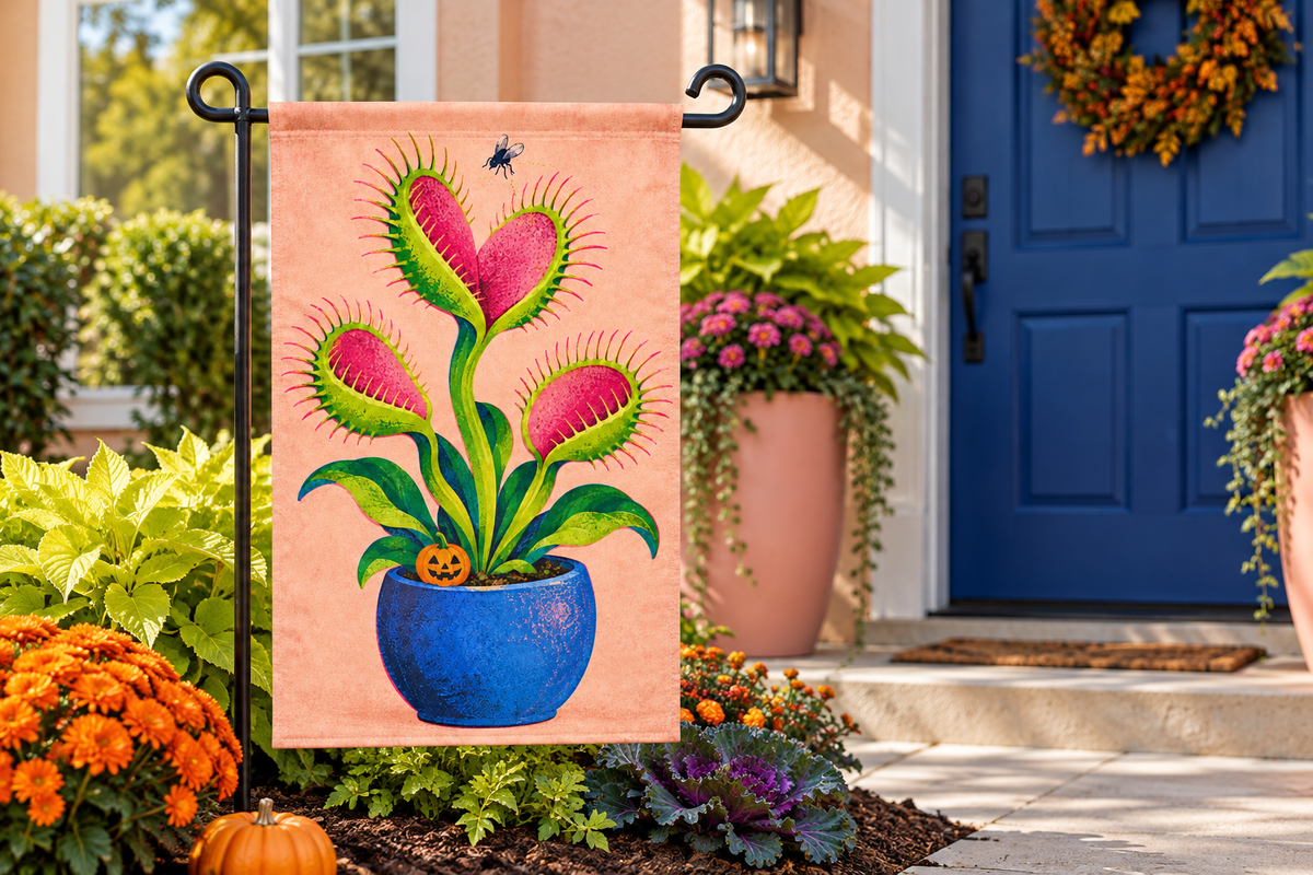 Monster Venus Flytrap Printed Garden Flag, lifestyle view 4: One flag on its separate black garden stake in a mailbox garden with restrained October seasonal planting, wide but product-led welcoming suburban scene.