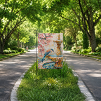 Mosaic bird fountain garden flag displayed along a green tree-lined pathway