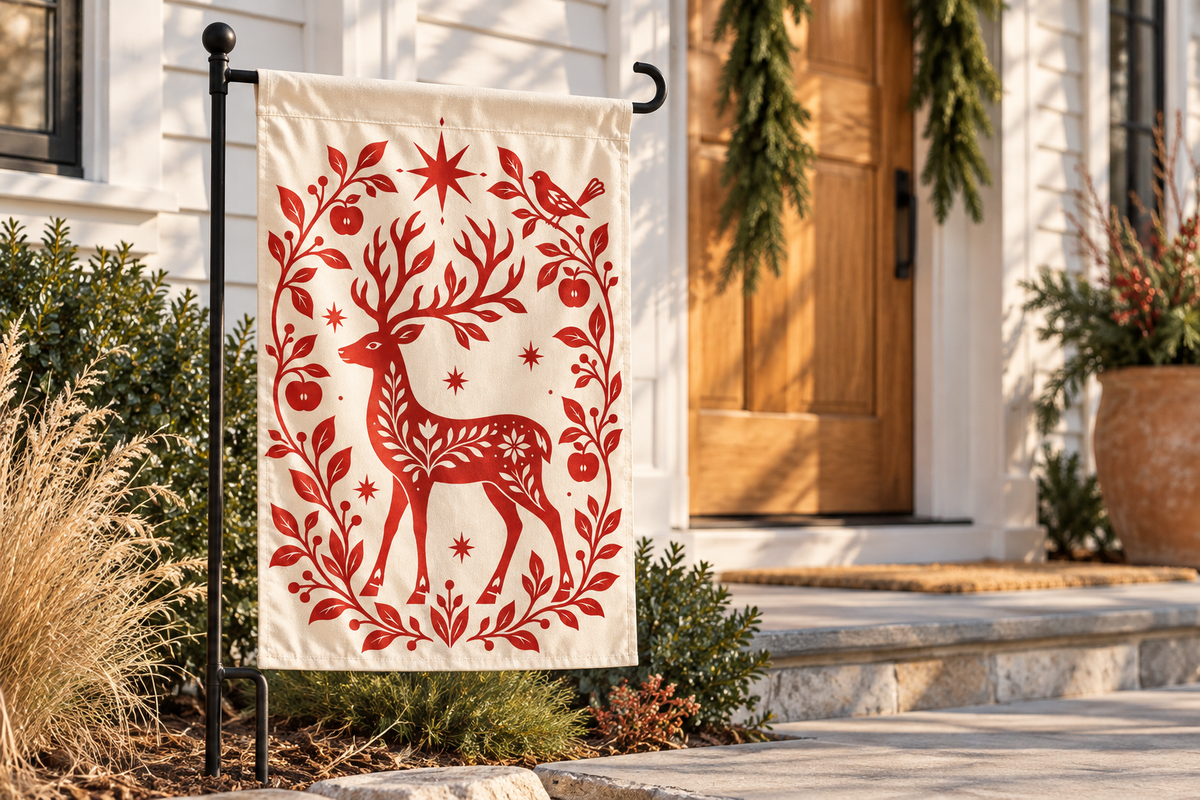 Nordic Reindeer Christmas Printed Garden Flag garden flag, lifestyle view 2: A modern white clapboard house with a natural cedar front door and a minimal evergreen garland.