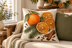 Orange & Clove Christmas Printed Pillow Cover, lifestyle view 2: A prominent single pillow on a sofa beside one plain solid-colored cushion; medium interior composition, product fills at least 40 percent of frame.