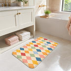 Pastel harlequin bath mat placed beside a bright bathroom tub.