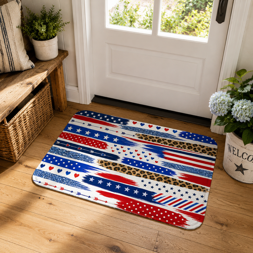 Vibrant Americana themed multi-pattern doormat placed at a white wooden front door entryway next to a welcome planter.