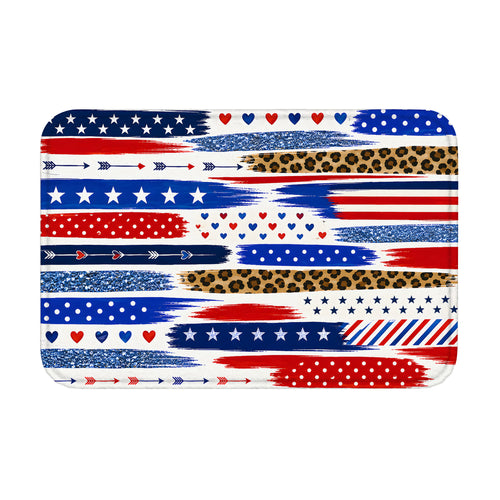 Studio shot of a rectangular decorative floor mat featuring an artistic collage of Americana patriotic stripes, stars, hearts, and leopard textures.