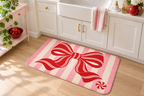 Peppermint Bow Christmas Printed Floor Mat, lifestyle view 2: One mat on the kitchen floor in front of a sink or coffee station, full printed surface readable, no furniture hiding the design.